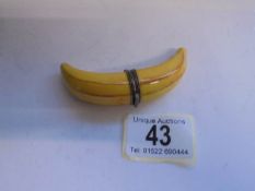 A Limoges novelty pill box in the shape of a banana.