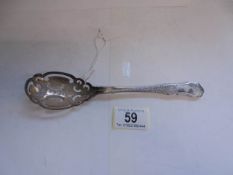 An ornate silver spoon, 55 grams.