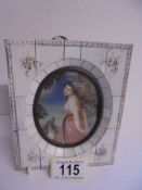 An oval portrait of a lady in an ivorex frame.