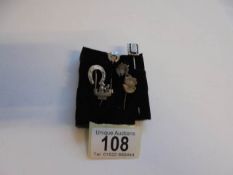 Six silver stick pins.