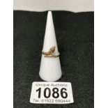 A 9ct gold snake ring with garnet eyes - size N (total weight 1.73g)