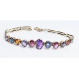 An antique multi-gem set bracelet, bezel set round and oval stones including zircon, spinel,