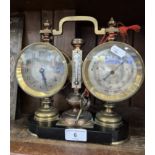 An antique French desk or mantle weather station featuring a clock, aneroid barometer and a