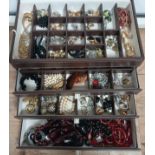 A jewellery box containing assorted costume jewellery.