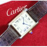 CARTIER, a ladies silver gilt Tank wristwatch, case measuring approx. 30mm x 23mm, with leather