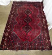 Dark red and black ground rug with geometric design - 2.06m x 2.89m Please note descriptions are not