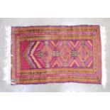 Red ground prayer rug with geometric pattern and end tassels - 0.82m x 1.42m Please note