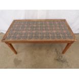 Mid century tile topped teak coffee table, standing on tapering legs - 53cm x 98cm x 43cm tall