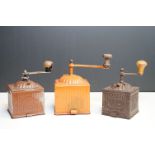 Three vintage toleware coffee grinders of graduating size, one marked F B and another Coff, the