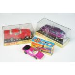 Three cased / boxed diecast models to include 2 x Dinky (131 Jaguar E Type 2+2 in purple and 116