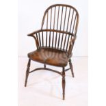 19th century ash Windsor chair, having hooped and stick back upon shaped seat, raised on turned legs