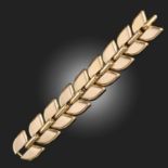 BOUCHERON, A GOLD TANK TRACK BRACELET C1940, of tapering chevron and triangular links in 18ct yellow