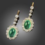 A PAIR OF EMERALD AND DIAMOND DROP EARRINGS, the oval emerald cabochons set within a surround of old