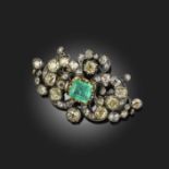 A VICTORIAN EMERALD AND DIAMOND BROOCH/CLASP, centred with a claw-set step-cut emerald within a