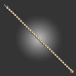 A DIAMOND LINE BRACELET, set with round brilliant-cut diamonds in yellow gold setting, stamped BH