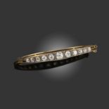 A LATE 19TH CENTURY DIAMOND BANGLE, set with graduated old cushion-shaped diamonds in silver and