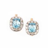 A PAIR OF BLUE TOPAZ AND DIAMOND EARRINGS, each set with a mixed-cut blue topaz within a pierced