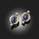 A PAIR OF SAPPHIRE AND DIAMOND CLUSTER EARRINGS, set with oval-shaped sapphires within a surround of