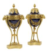 A PAIR OF FRENCH ORMOLU AND PORCELAIN URNS IN LOUIS XVI STYLE, LATE 19TH CENTURY each with a lid