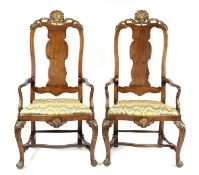 A PAIR OF WALNUT AND PARCEL GILT ARMCHAIRS NORTH EUROPEAN, EARLY 18TH CENTURY each with a shell