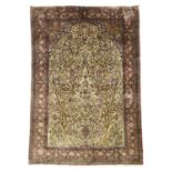 A KASHAN RUG CENTRAL PERSIA, C1930 the ivory field with an urn issuing flowers, flanked by two