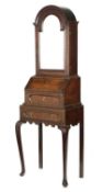 A QUEEN ANNE OAK BUREAU CABINET ON STAND C.1710 the domed top with a hinged door inset with a