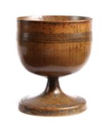 A TREEN FRUITWOOD TURNED FOOTED BOWL OR LOVING CUP 18TH CENTURY with a band of incised lines to