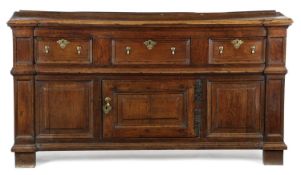 A WILLIAM AND MARY FRUITWOOD AND OAK ENCLOSED DRESSER BASE C.1700 having a highly impressive one
