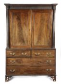 A GEORGE III MAHOGANY LINEN PRESS LATE 18TH CENTURY the inverted breakfront cornice decorated with