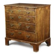 A GEORGE II WALNUT CHEST C.1730-35 with cross and feather banding, the quarter burr veneered top,