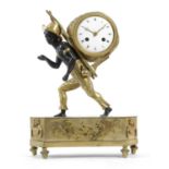 A FRENCH EMPIRE GILT AND PATINATED BRONZE PORTE FAIX MANTEL CLOCK EARLY 19TH CENTURY the brass
