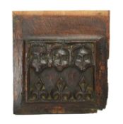 AN ENGLISH CARVED OAK PANEL ENGLISH, C.1500 AND LATER carved with three masks depicting father,