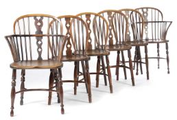 A HARLEQUIN SET OF SIX YEW AND ELM LOWBACK WINDSOR CHAIRS BY AMOS, GRANTHAM, EARLY 19TH CENTURY each