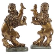 A PAIR OF GILTWOOD AND PAINTED RAMPANT LIONS IN THE 17TH CENTURY MANNER each boldly carved