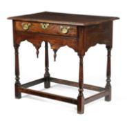 A RARE WELSH OAK SIDE TABLE VALE OF GLAMORGAN, EARLY 18TH CENTURY the boarded top above a frieze
