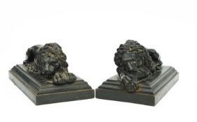 A PAIR OF PATINATED CAST IRON MODELS OF RECUMBENT LIONS AFTER ANTONIO CANOVA, LATE 19TH CENTURY on