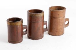 TWO VICTORIAN TREEN PINT MEASURES LATE 19TH CENTURY each with a pierced handle and stamped 'PINT',