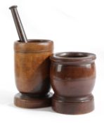 A TREEN LIGNUM VITAE MORTAR 19TH CENTURY on a short ogee stem and circular foot, with an