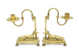 A PAIR OF BRASS GREYHOUND CANDLESTICKS MID-19TH CENTURY each with a detachable scroll arm candle