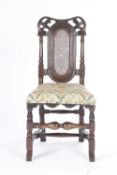 A WILLIAM AND MARY WALNUT SIDE CHAIR C.1690-1700 the leaf and scroll crest above a caned back and