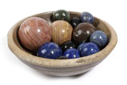 A TREEN SYCAMORE DAIRY BOWL 19TH CENTURY with ten marble spheres and four marble eggs (15) 34.5cm