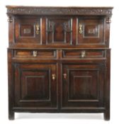 A CHARLES II OAK COURT CUPBOARD NORTH COUNTRY, C.1660 with carved floral meandering and pendant hung
