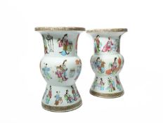A PAIR OF CHINESE CANTON FAMILLE ROSE VASES 19TH CENTURY painted with three bands of figures in