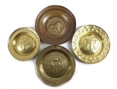 A GERMAN BRASS 'ADAM AND EVE' ALMS DISH 18TH OR 19TH CENTURY with repoussé decoration, another,