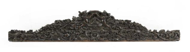 A CARVED WALNUT AND OAK CRESTING RAIL LATE 17TH CENTURY relief carved with scrolling leaves, flowers