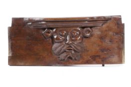 A FRENCH CARVED WALNUT MISERICORD SEAT WITH CORBEL MID-15TH CENTURY carved with a bearded male