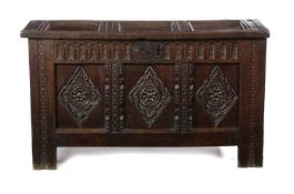 A CHARLES I OAK COFFER C.1630-40 the triple panelled top revealing a lidded till above a gouge