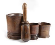 A TREEN LIGNUM VITAE MORTAR MID-18TH CENTURY with incised lines, a tapered body and ogee moulding,