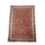 A KHAMSEH CARPET C.1930 the madder field of tribal and zoomorphic devices around three mid blue