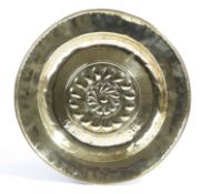 A GERMAN BRASS ALMS DISH NUREMBERG, 16TH CENTURY the centre with a repoussé whorl within a border of